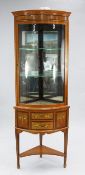 An Edwardian Sheraton Revival floral painted satinwood corner display cabinet, with single bowed