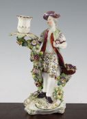 A Derby porcelain candlestick figure, late 18th century, modelled as a gentleman holding a posy of