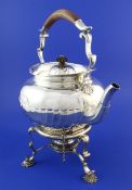 A late Victorian silver tea kettle on stand and later associated plated burner, with demi-spiral
