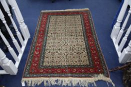 A Central Persian rug, with field of scrolling foliage on an ivory ground, with multi row polychrome