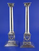 A good pair of George III silver ionic column candlesticks by John Cox engraved with the arms of
