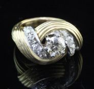 A 1940's French 18ct gold and diamond dress ring, of reeded scrolling design, the central diamond