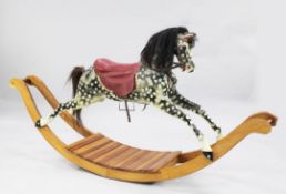 A black and grey painted rocking horse, with red saddle, now on a later rocking base, overall length