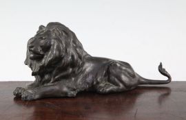 A patinated bronze model of a recumbent lion, unsigned, 9in.