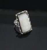 A Chinese silver mounted white jade ring, early 20th century, the rectangular white jade plaque