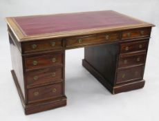 A Victorian mahogany pedestal partner's desk, with red leather gilt tooled writing surface above