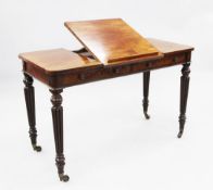 A William IV mahogany library table, with central hinged book rest over two frieze drawers, opposing