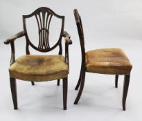 A set of twelve Hepplewhite style mahogany dining chairs two with arms, with shield backs, with