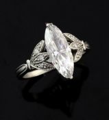 A good platinum and single stone marquise diamond ring, with diamond set foliate shoulders and