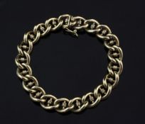 A gold curb and coil link bracelet, unmarked, 31 grams, 6.75in.