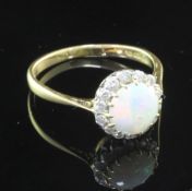 A late 1970's 18ct gold, white opal and diamond cluster ring, size T.