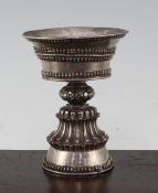 A Tibetan silver yak butter lamp, 19th century, the pan shaped bowl above a baluster stem, with