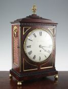 A Regency brass mounted mahogany bracket timepiece, with circular enamelled dial signed Justin