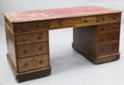 A Victorian mahogany pedestal desk, gilt tooled, red leather writing surface above an arrangement of