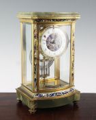 An early 20th century French champlevé enamelled ormolu and green onyx four glass mantel clock, with
