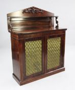 A Victorian rosewood chiffonier, the architectural back with single shelf above two brass grill