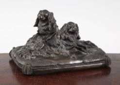 A late 19th / early 20th century patinated bronze group modelled as two spaniels, on a rectangular