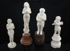 A late 19th century German carved ivory figure standing on a barrel, together with a similar