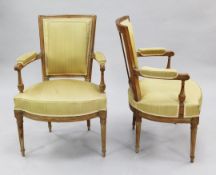 A set of four French Louis XVI style beech framed open armchairs, with angular upholstered backs and