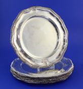A set of eight early 1970's silver dinner plates by Roberts & Belk, of shaped circular form, with