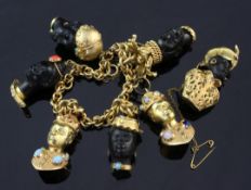 A mid 20th century Italian 18ct gold charm bracelet, hung with six 18ct gold or carved obsidian?,