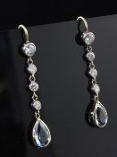 A pair of aquamarine and diamond drop earrings, each set with a pear shaped aquamarine and five