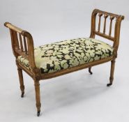 A Louis XVI style walnut window seat, with raised scrolled sides and tapering fluted uprights with