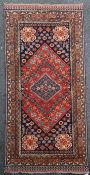 A Caucasian rug, with field of polygons and animals on a red and blue ground, with five row