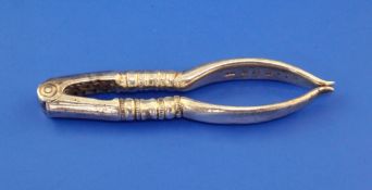 A pair of George V silver nut crackers by Collins & Co, (Dryad Art Metal Works), Birmingham, 1912,