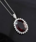 A white gold, red tourmaline and diamond set pendant on white metal chain, with diamond set bale,