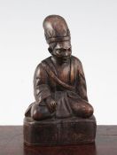 A Chinese Jichimu seated figure of a monk, 19th century, on a shaped plinth, 8cm