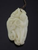 A Chinese white jade carving of a boy clambering on a finger citron, carved in relief with leaves, a