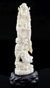 A Japanese walrus ivory okimono of Kwannon and a boy, early 20th century, both standing on a