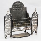 A 19th century cast iron and cut steel fire grate, the fire basket with arched back flanked