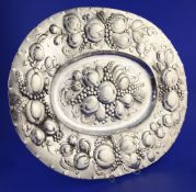 A late 19th/early 20th century German 800 standard silver charger, of oval form and embossed with