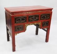 A provincial Chinese red lacquered side table, with an arrangement of five floral painted drawers on