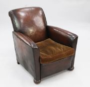 A 1930's brown leather upholstered armchair, with brown velvet upholstered seat cushion