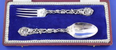 A cased Victorian silver christening pair by George Adams, with cast handles, pierced and