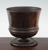 A late 17th century lignum vitae wassail cup, ring turned on circular spreading foot, 7.25in.,