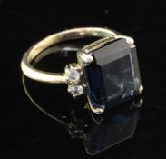 A gold, blue spinel and white sapphire? ring, the emerald cut spinel flanked by two colourless