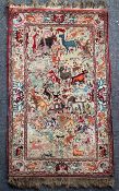 An early 20th century Kirman hunting rug, with field of wild animals and serpents on an ivory
