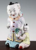 A Chinese enamelled porcelain group of boys, 20th century, the largest boy carrying another on his