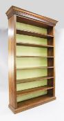 A large oak open bookcase, fitted with six shelves between reeded sides, on plinth base, H.8ft