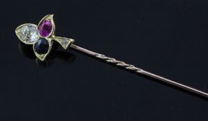 An Edwardian gold, diamond, ruby and sapphire set trefoil stick pin, 2.5in.