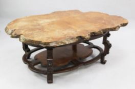 A decorative modern coffee table, the top formed as a slice of walnut on a chinoiserie hardwood