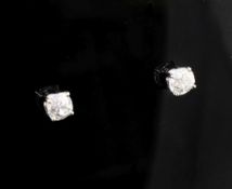 A pair of 18ct gold and solitaire diamond ear studs, the two old cut stones with an approximate