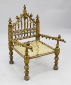 A North Indian parcel gilt and polychrome painted chair, the triangular shaped back with turned