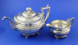 A George IV Scottish silver teapot, of circular form with engraved armorial and embossed with