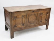 An early 18th century oak coffer, with geometric panelled front and stile feet, W.4ft 3in. D.1ft