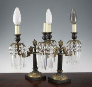 A pair of Victorian painted bronze and ormolu twin branch table lustres, with prismatic drops and